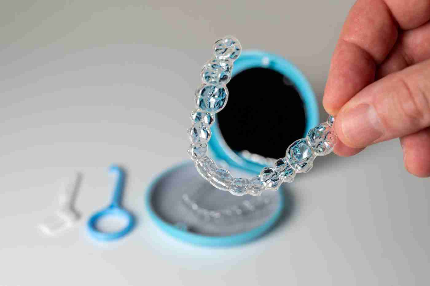 Hand holding a clear aligner tray