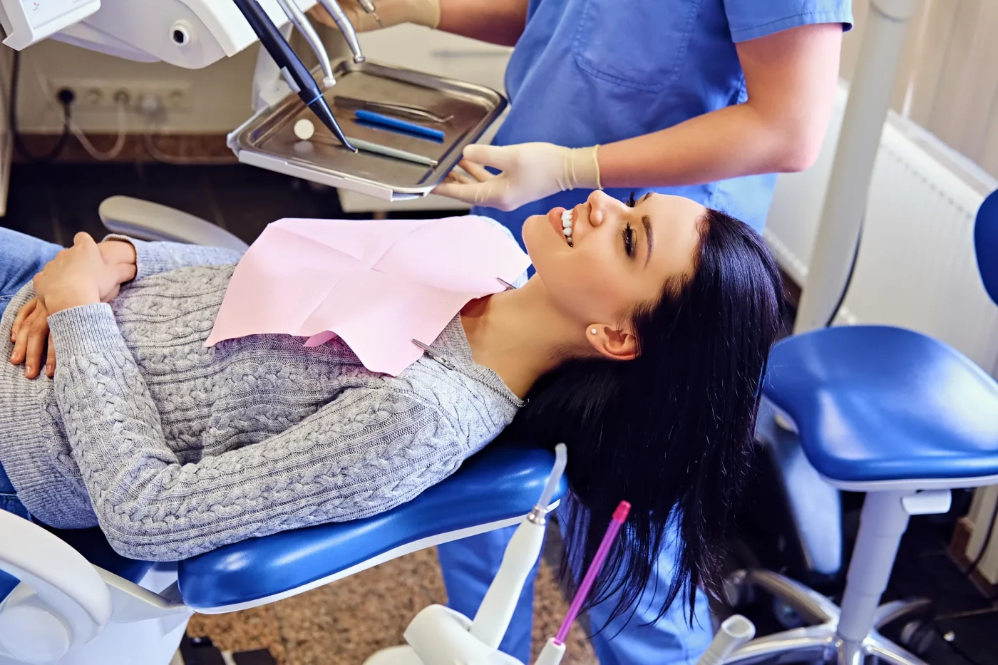 Dentist examining a patient's teeth during a preventive dental exam in Flushing, NY